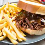 shredded bbq beef sandwich with french fries