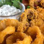 What Does Calamari Taste Like? Plate of deep fried calamari and tartar sauce